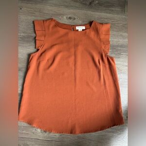 Monteau Orange Sleeveless Blouse with Ruffle Details.